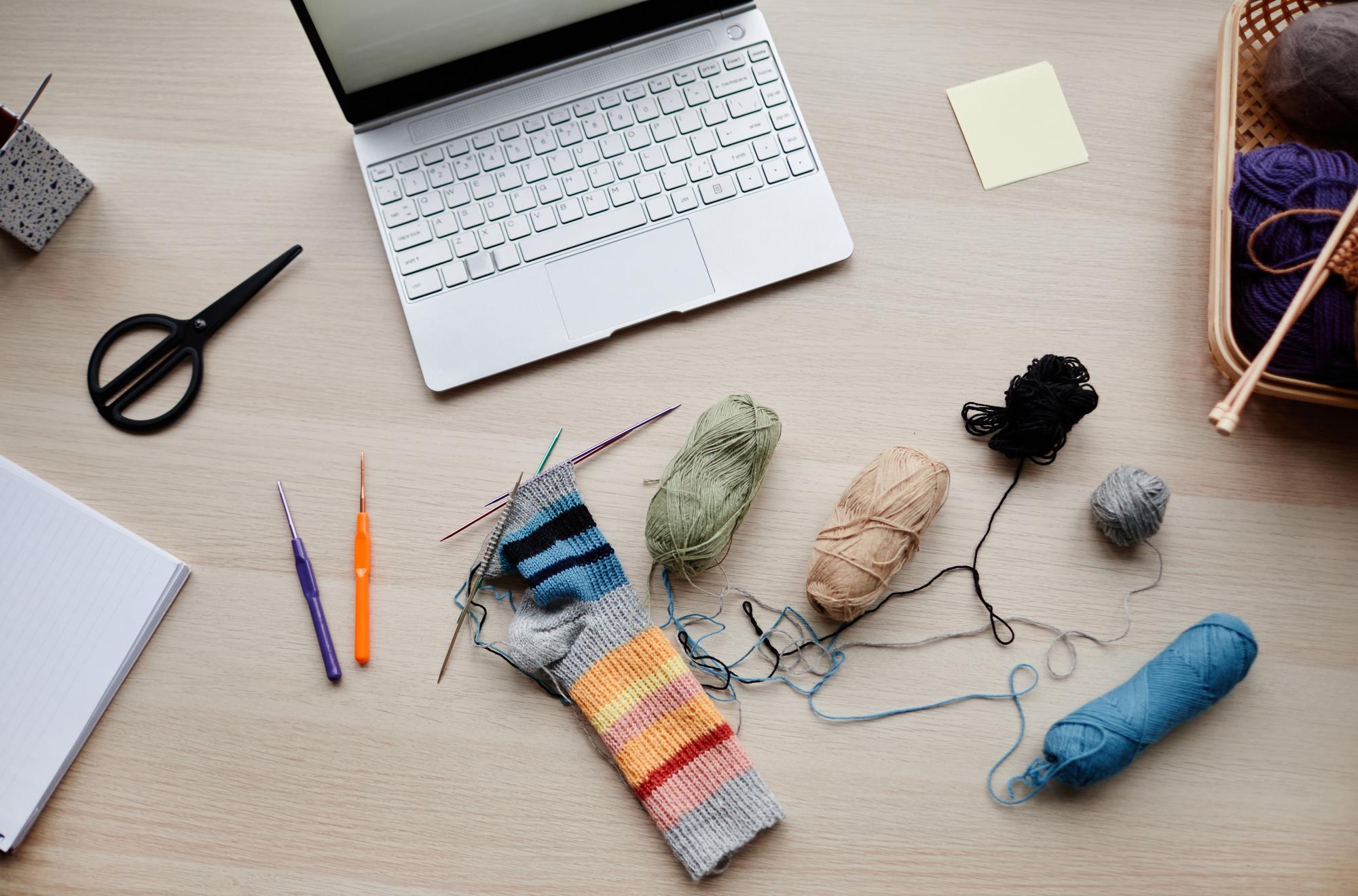 Workspace with threads and sketches for embroidery